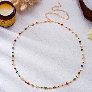 Detailed macro view of colorful round rhinestone gold metal body chain for beach vacation