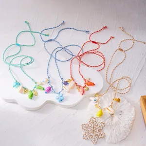 Detailed view of colorful Bohemian beach body chains with shell and starfish charms