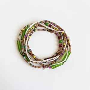 Detail of multi-layered Bohemian colorful seed bead waist chain on white background