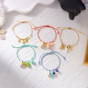 Detailed view of bohemian beach-style braided bracelets with shell and starfish charms