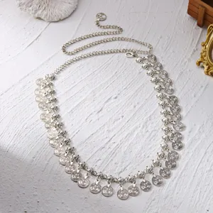 Antique silver ethnic waist chain featuring hanging coin tassels on textured background