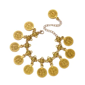 Close-up of bohemian gold coin tassel body chain featuring intricate embossed patterns