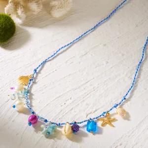 Detailed view of a Bohemian beach waist chain featuring colorful shell and starfish charms.