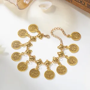 Detailed macro view of antique gold coin charms on an ethnic belly dance waist chain