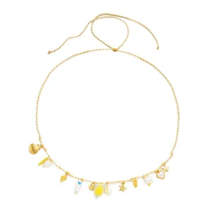 Close-up detail of a bohemian beach waist chain with gold starfish and shell charms.