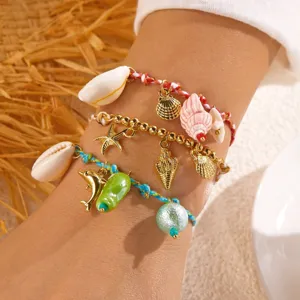 Bohemian beach style layered bracelet set featuring natural shells and golden starfish charms