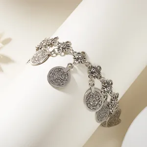 Detailed view of antique silver belly dance waist chain with embossed coin pendants.