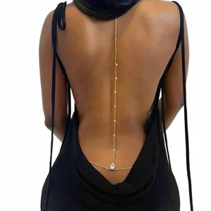 Detailed view of a bohemian gold back drop body chain for backless dresses.