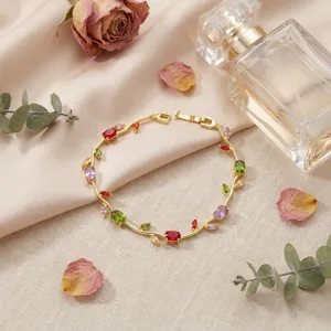 Detail of a luxury gold vine bracelet featuring vibrant multi-color crystal stones.
