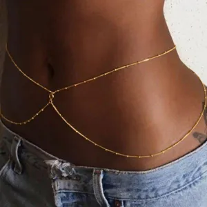 Close-up view of a minimalist bohemian gold plated body chain waist jewelry for women