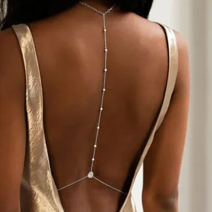 Elegant silver back body chain featuring delicate pearls shown on a metallic dress