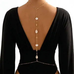 Elegant bohemian gold body chain featuring shell and starfish charms for open back dresses