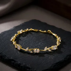 Elegant gold-plated leaf bracelet with sparkling crystals shown in high detail