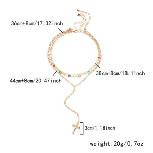 Detailed size guide for multi-layered gold necklace with colorful rhinestone cross