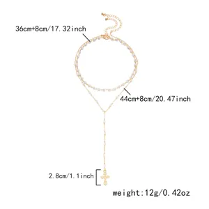 Detailed dimension view of layered gold pearl cross necklace with length and weight info