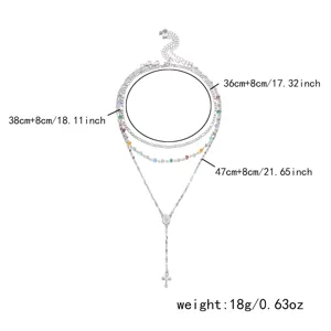 Detailed view of silver layered necklace with cross pendant and size annotations