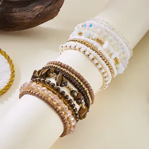 Macro detail of Bohemian stacked bracelet set with natural wooden beads and tiger eye