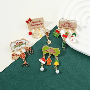 Detail of Christmas enamel brooches with dangling snowman and gingerbread man charms