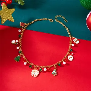 Festliche Weihnachtskette mit Weihnachtsmann-, Baum- und Schneemann-Anhängern an Goldkette.