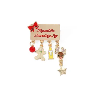 Festive Christmas enamel brooch featuring gingerbread man and reindeer dangling charms