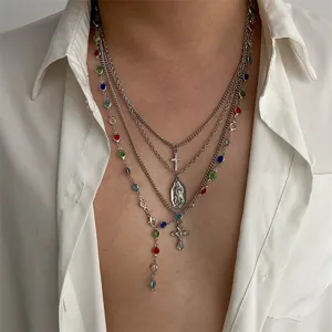 Detailed macro shot of layered silver cross necklace featuring vibrant multicolored beads