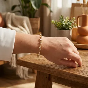 Close-up view of elegant gold leaf bracelet with clear marquise stones on a wrist