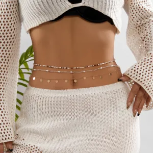 Detail shot of a sexy multi-layered bead and gold sequin belly chain for women
