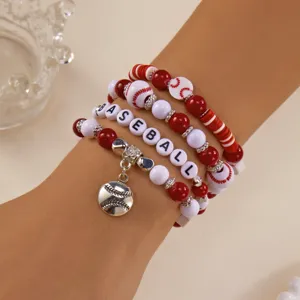 Close-up of red and white baseball beaded bracelet set with sports theme charm