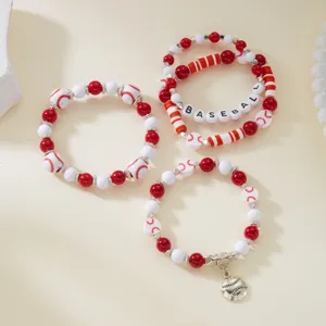 Close-up of red and white baseball-themed beaded bracelet set with sports charms