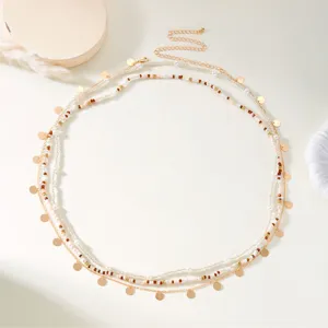 Detailed view of bohemian multi-layered beaded belly chain with gold sequins decor