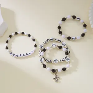 Detailed view of handmade beaded soccer bracelets with football letter beads and ball charms
