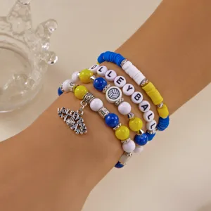 Close-up of blue and yellow volleyball themed beaded bracelet set on a person's wrist