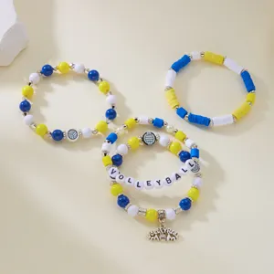 Detailed view of handmade volleyball bracelet set with yellow, blue, and white beads.