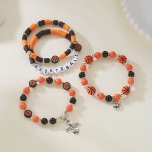 Close-up of basketball-themed beaded bracelet set with polymer clay and charms