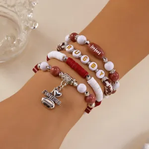 Close-up of a stacked rugby-themed bracelet set with clay beads and charms.