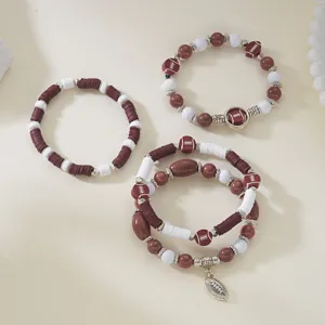 Detail of Game Day football-themed beaded bracelet set with maroon and white clay beads