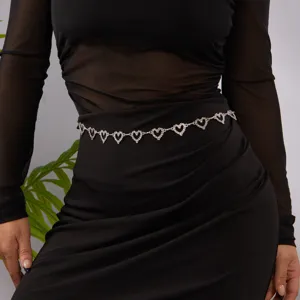 Close-up of bohemian silver heart-shaped metal chain belt with sparkling rhinestones