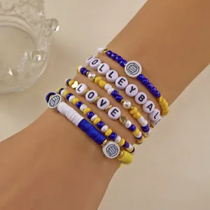 Close-up of blue and yellow volleyball themed beaded bracelet set with LOVE text on arm