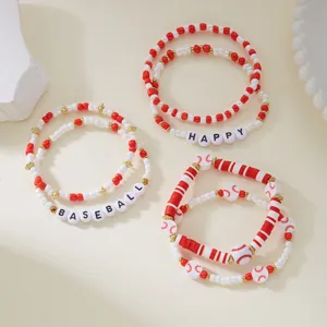Close-up of red and white baseball-themed beaded bracelets with Happy and Baseball text