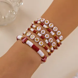 Detailed shot of stackable football bracelets with Gameday and Touchdown lettering