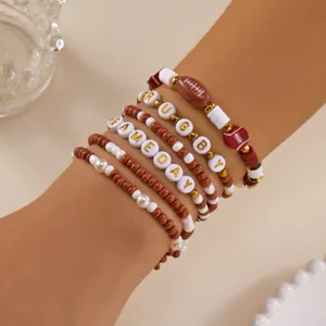 Detailed view of Game Day and Rugby themed polymer clay beaded bracelets on wrist