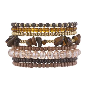 Close-up detail of bohemian beaded bracelet set with tiger eye stones and faceted crystals