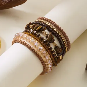 Detail shot of bohemian stacked bracelet set with natural wood and crystal beads