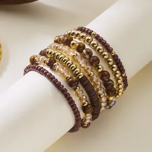 Detailed close-up of Bohemian stacked bead bracelet set with gold and wood beads