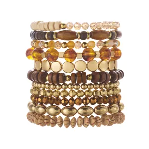 Detailed shot of bohemian multilayered beaded bracelet set with wood and gold accents