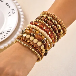 Stackable Bohemian bracelet set with wooden beads and amber accents worn on wrist