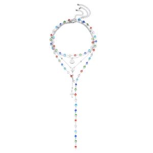 Detailed view of a multi-layered silver necklace with vibrant colorful rhinestones and cross