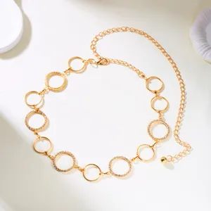 Detailed view of a gold hollow circle link waist chain with rhinestone accents