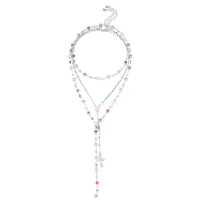 Close-up detail of silver layered necklace featuring vibrant rhinestones and cross pendant