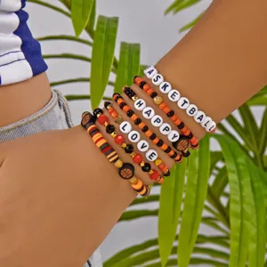 Detail of polymer clay beaded bracelets with Basketball, Happy, and Love letter beads